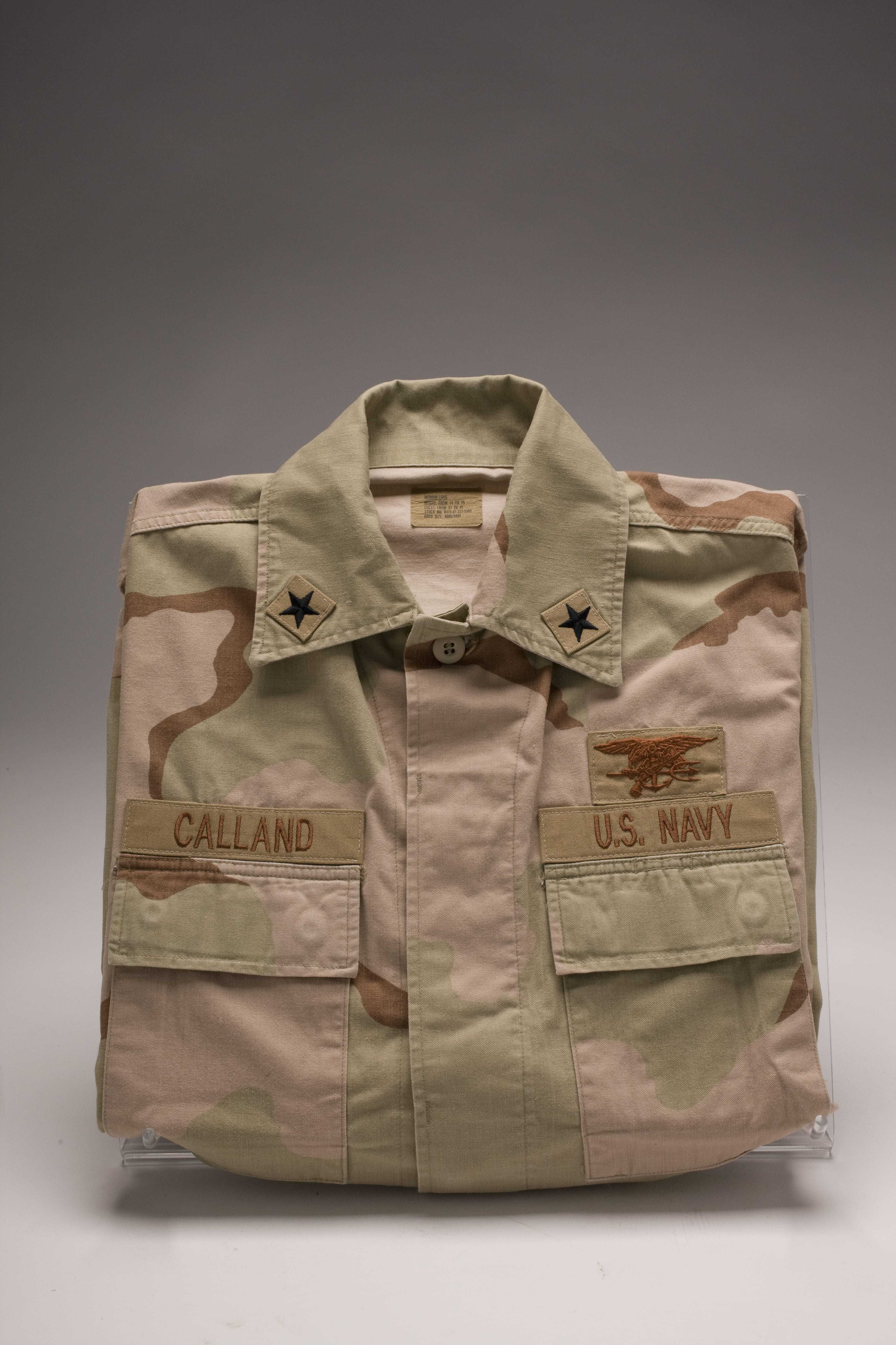 A khaki, brown, and green combat uniform top