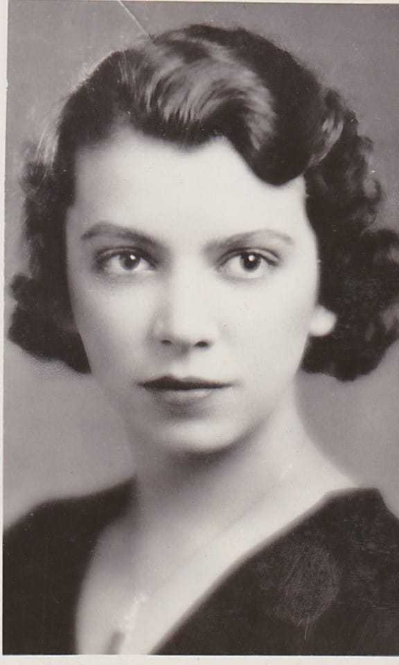 A black and white portrait photograph of Elizabeth wearing a thin necklace.